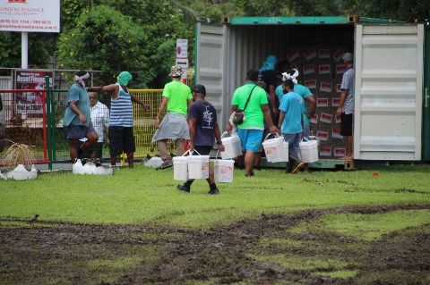 Aid workers carry supplies to Tongan communities.